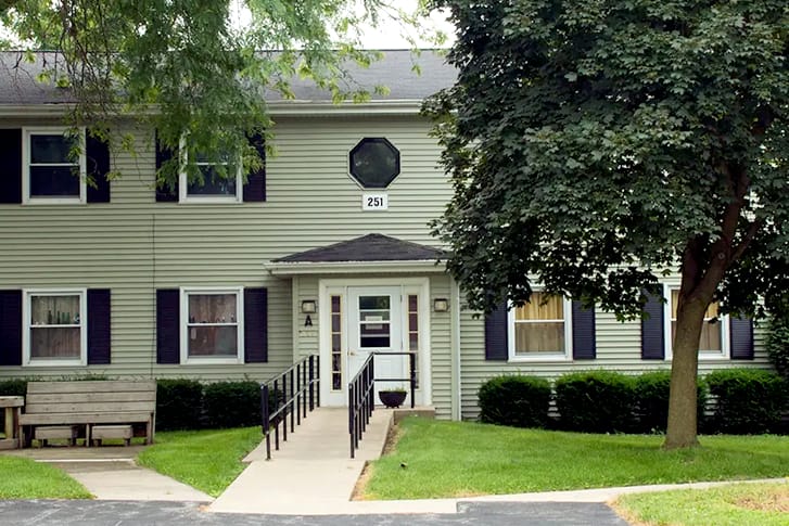 Exterior of a two-story Colonial style apartment building.