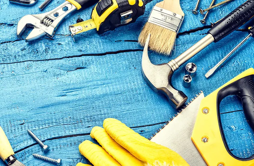Various tools lay on a blue tarp.