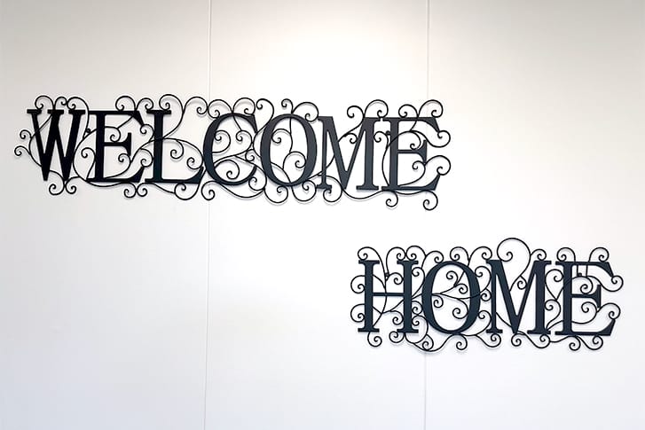Welcome Home written in black font on a white background.